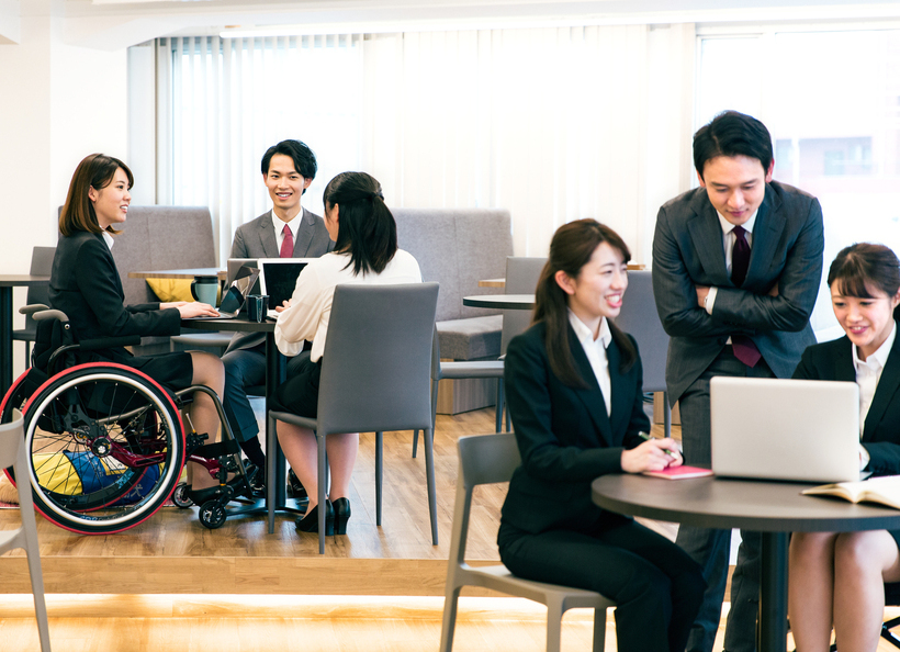 車椅子の人など数名で話している画像